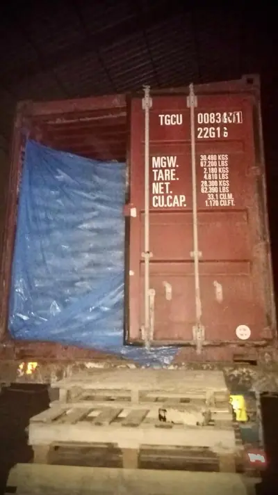 20 ft container with a blue liner loaded at night