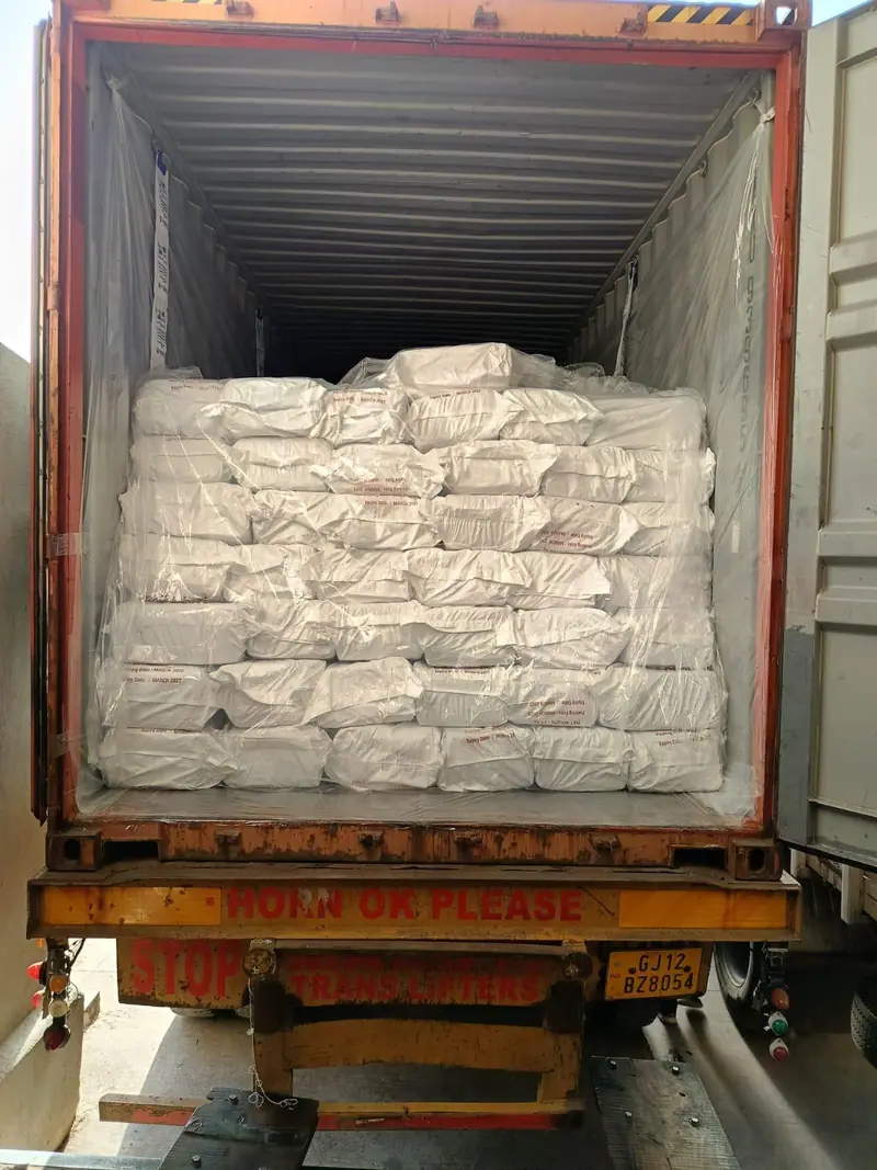 Container fully stuffed with white PP bags, ready for sealing