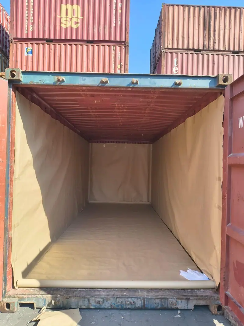 Empty 20 ft container lined with kraft paper before loading