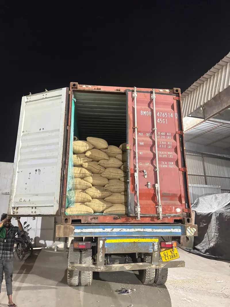 Jute bags loaded into a container at night