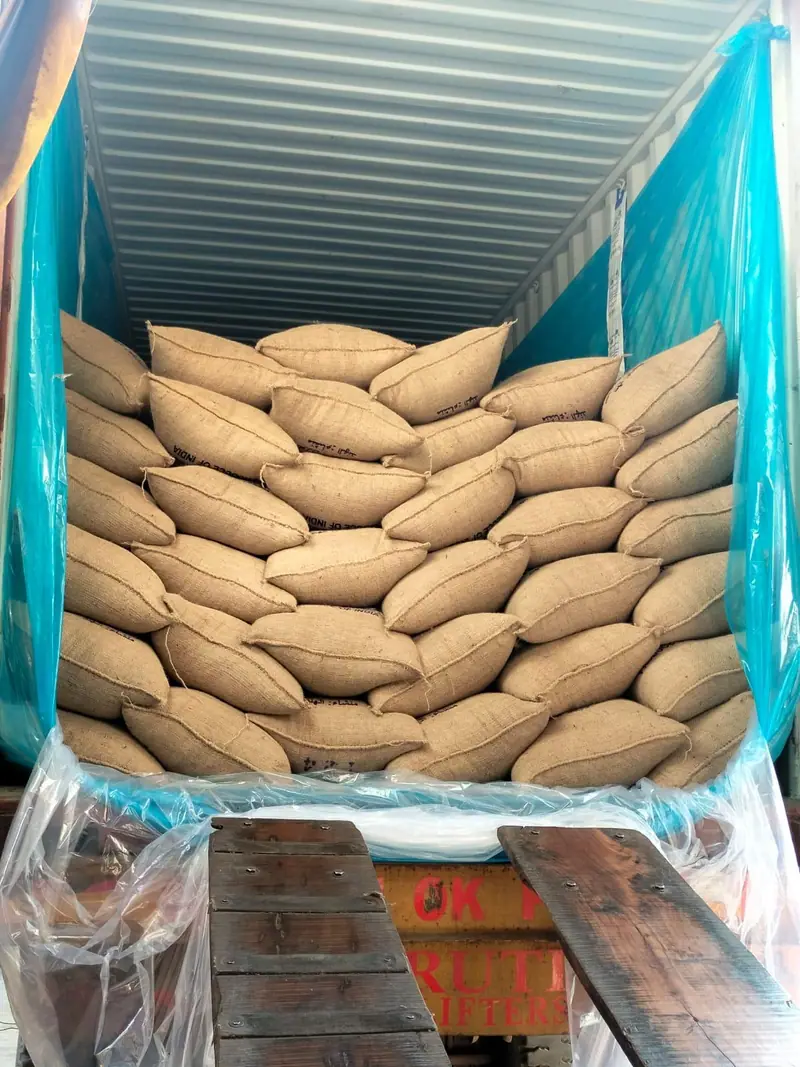 Jute bags stacked in a blue container liner