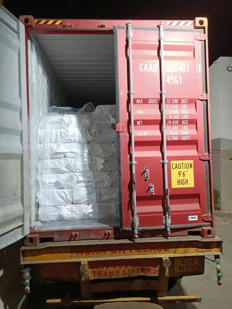 White bagged cargo in a lined 40 ft high-cube container