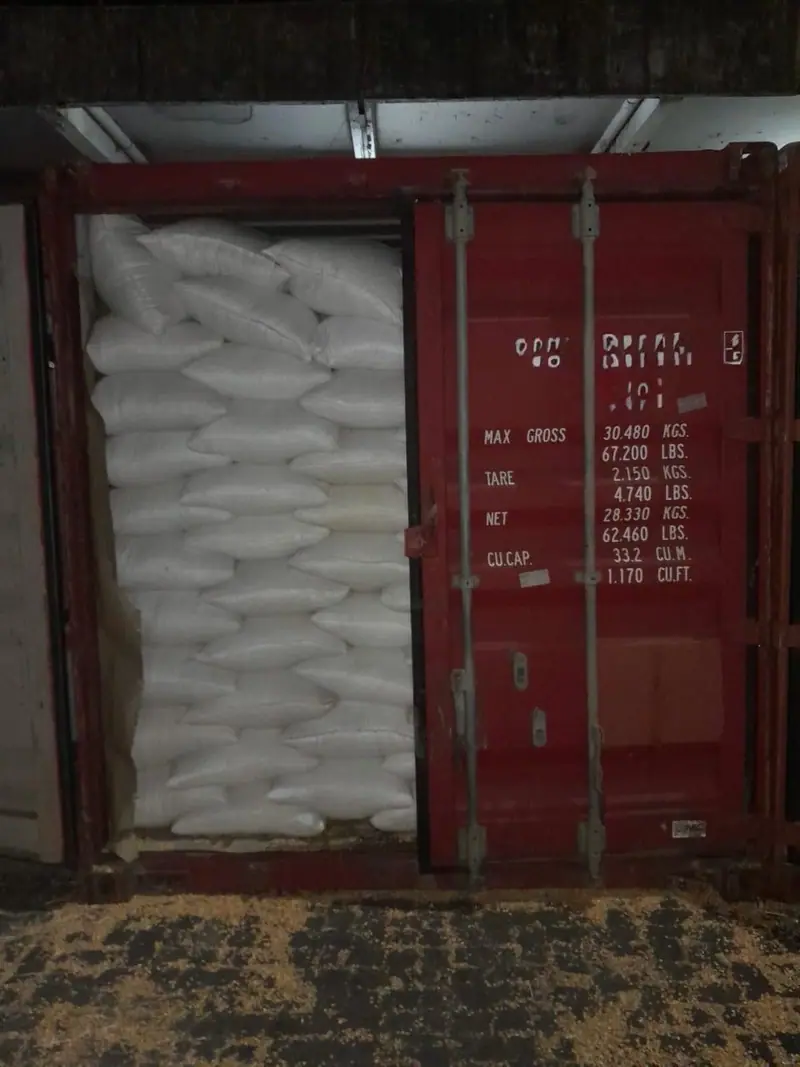 White bags stacked in a 20 ft container