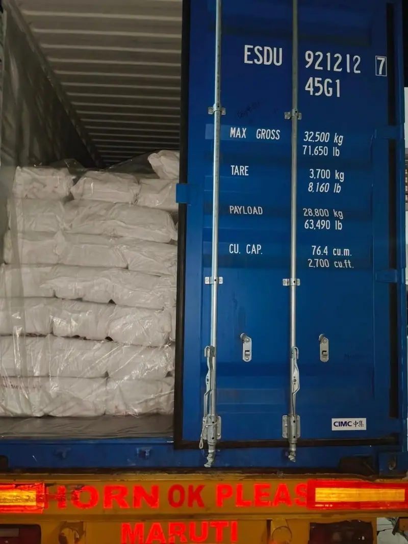 White PP bags loaded in a blue 40 ft high-cube container