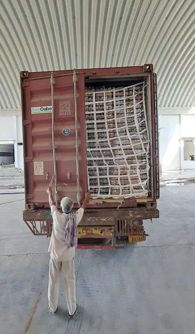 Worker fixing a cargo net before the container doors are closed