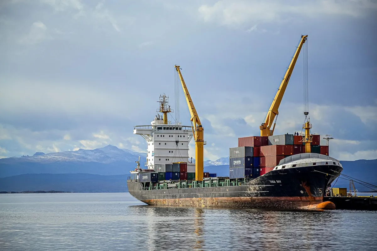 Container vessel with cranes, illustrating shipping export import terms such as FCL and POL