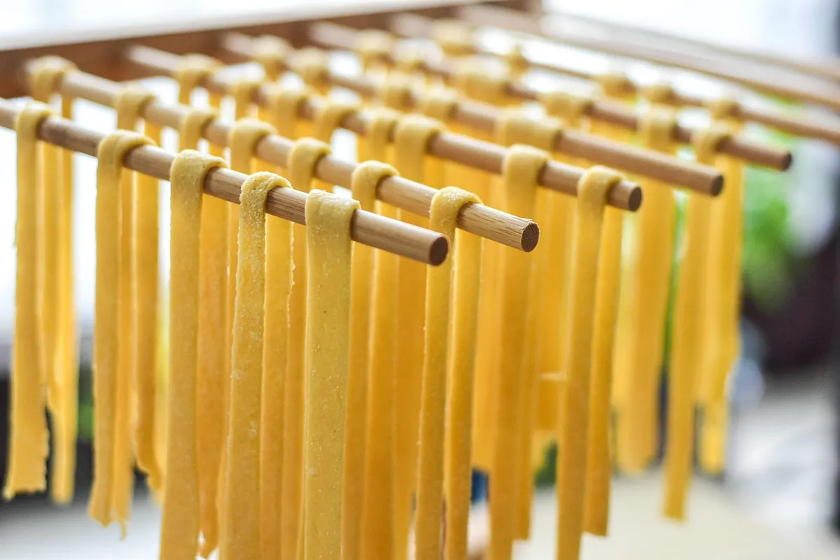 Fresh pasta drying on wooden racks, made from durum wheat semolina