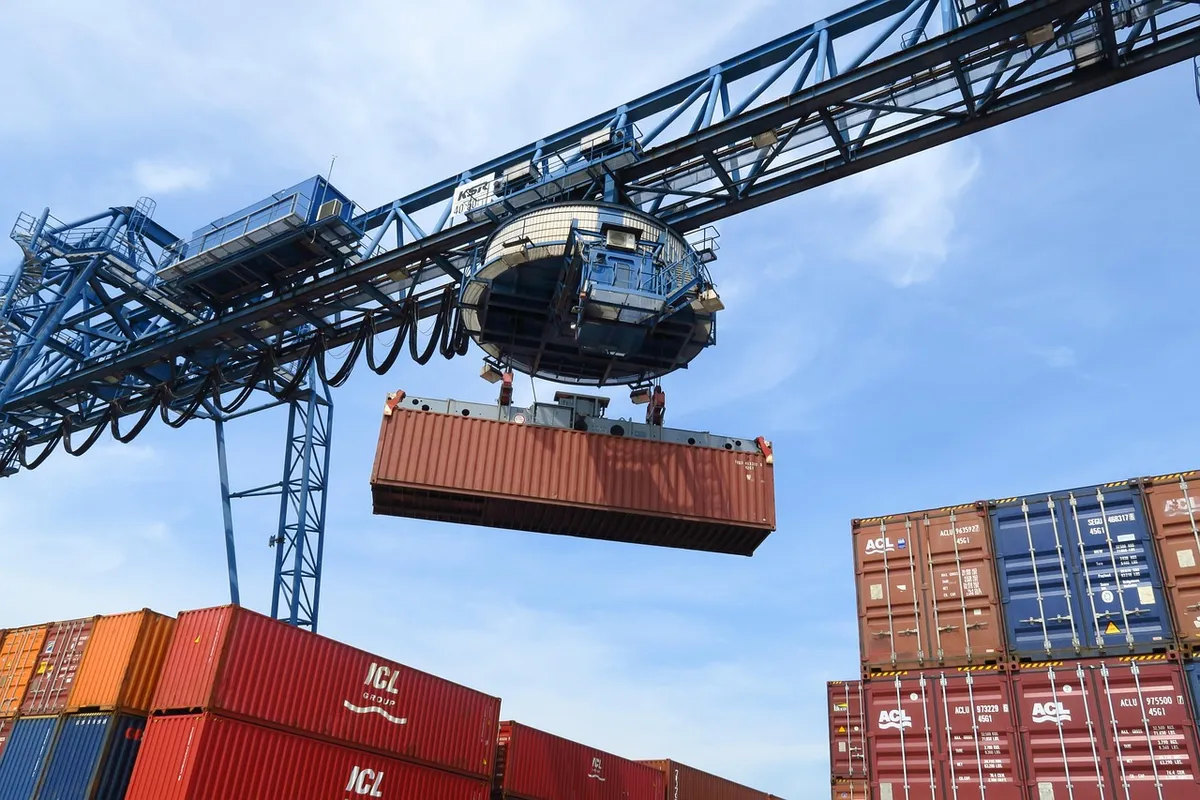 Crane lifting a shipping container listed on the bill of lading