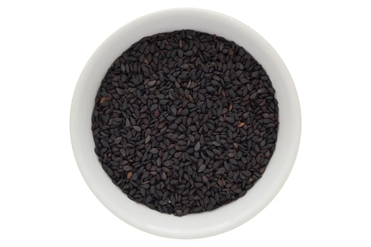 Bowl of whole black sesame seeds rich in minerals