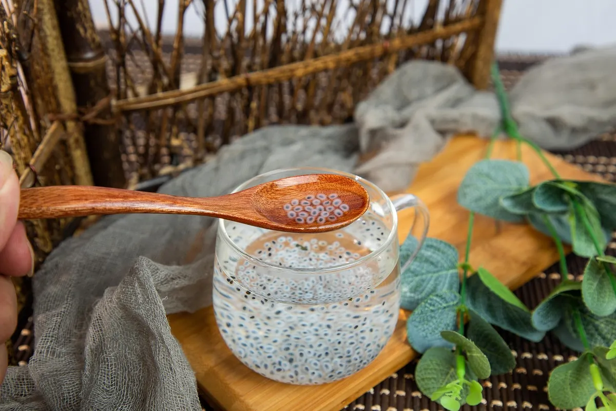 Soaked basil (sabja) seeds in a glass of water with white gel coats