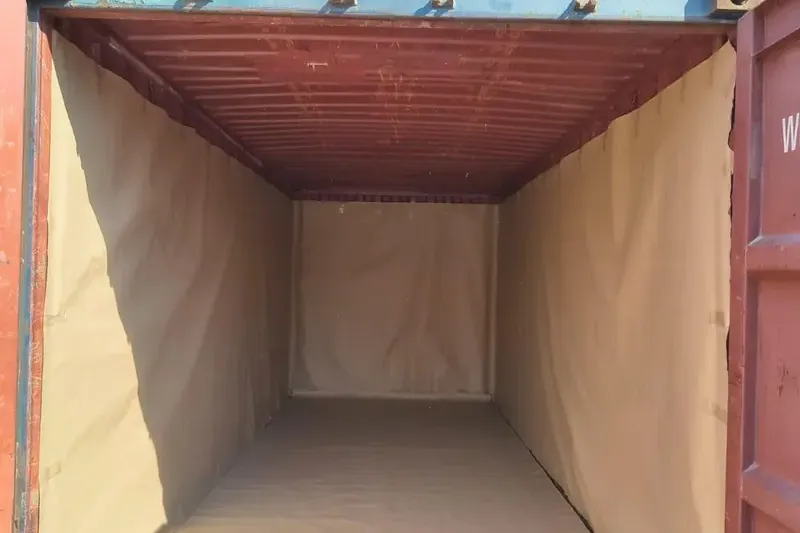 Empty 20 ft container lined with kraft paper before loading to protect cargo from moisture
