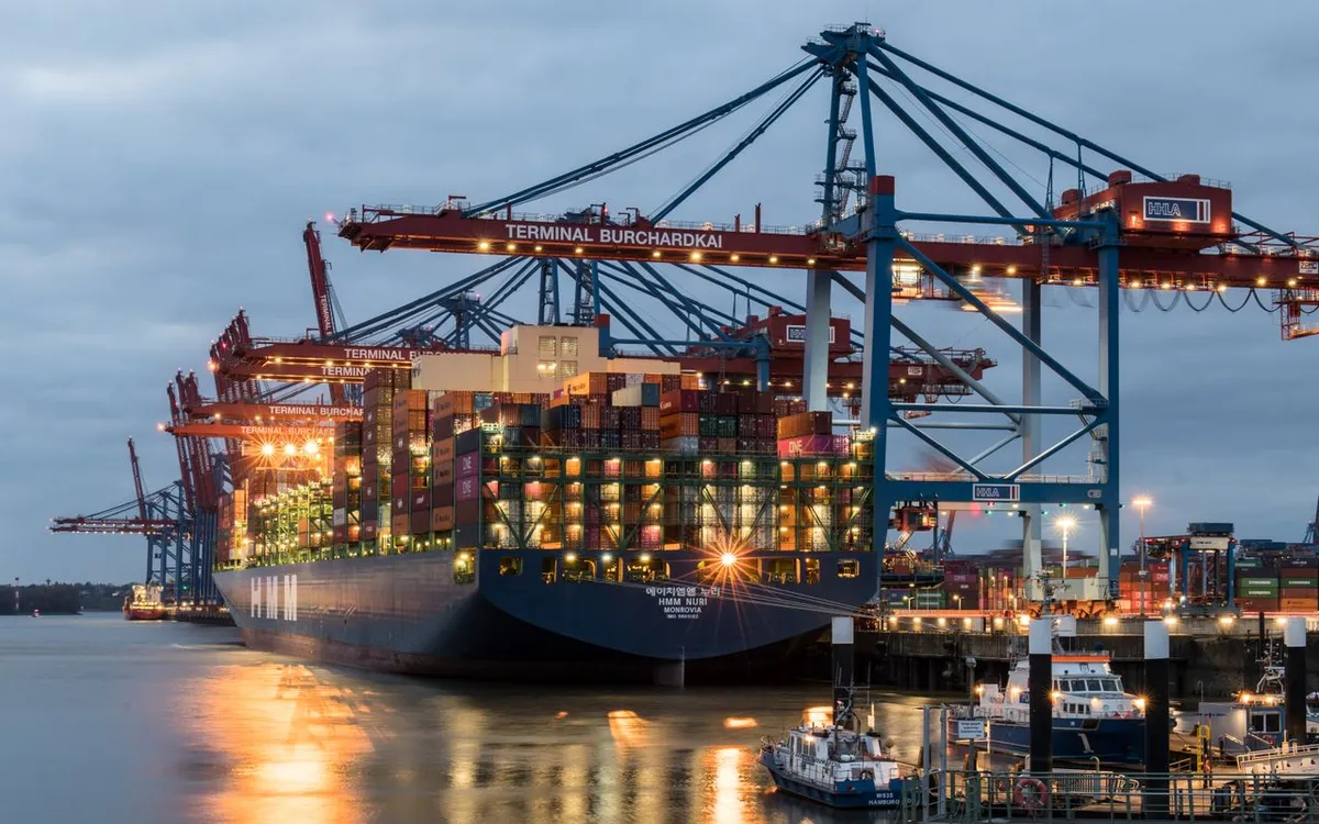 Container ship being loaded by gantry cranes at a port terminal