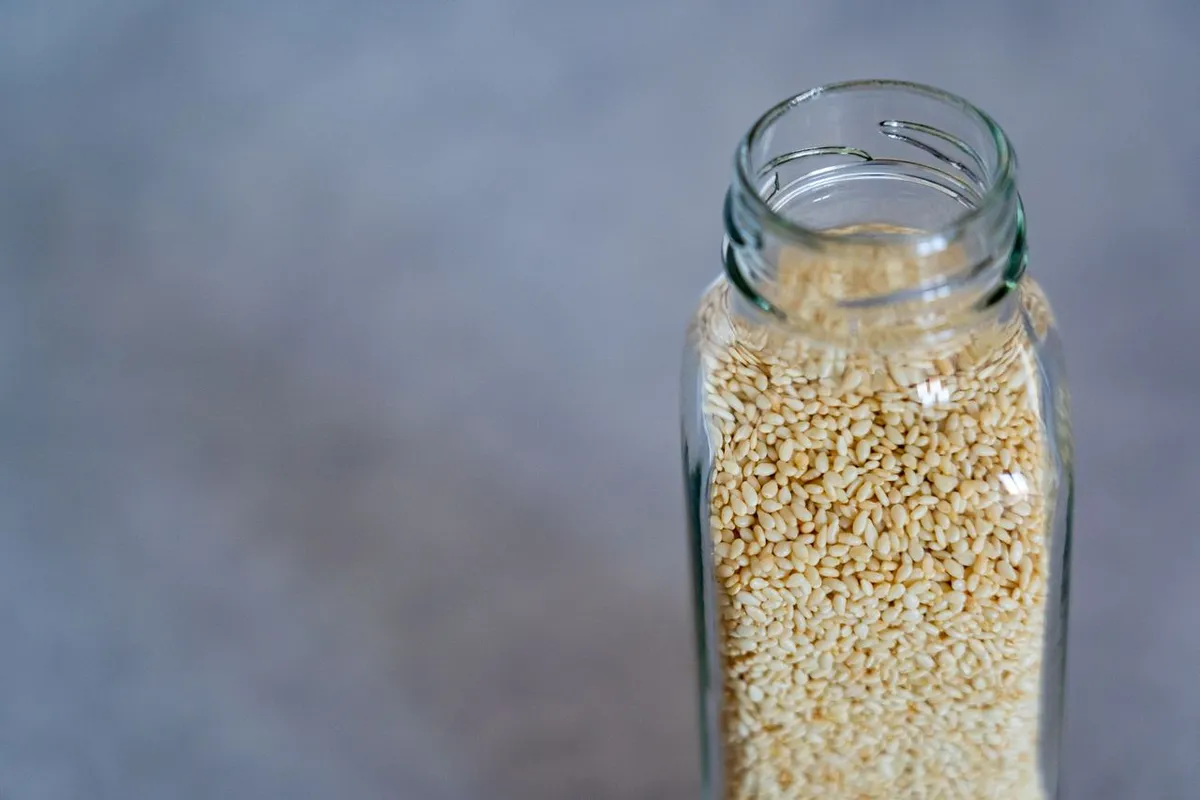 Glass jar of sesame seeds stored airtight so they do not go bad