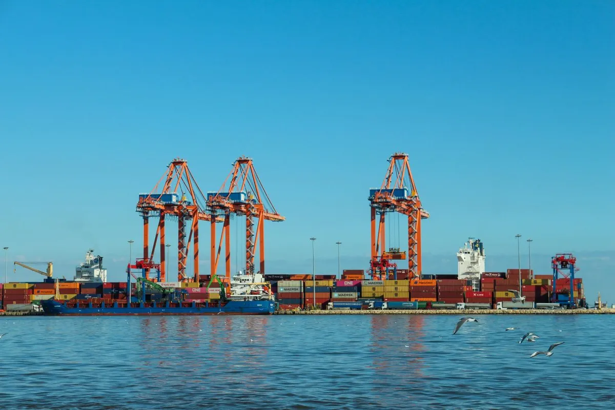 Port cranes at the port of loading where FOB delivery takes place