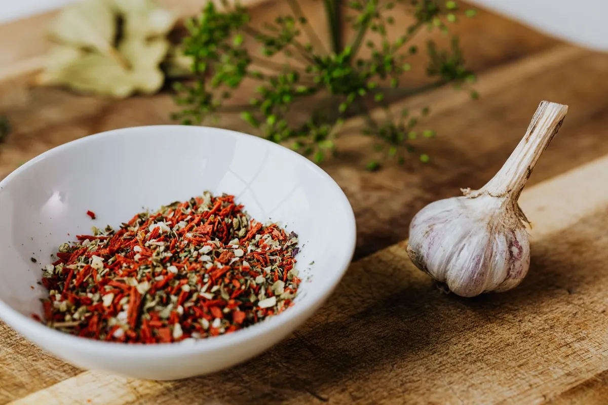 Dry seasoning blend with garlic, where granulated garlic is often used