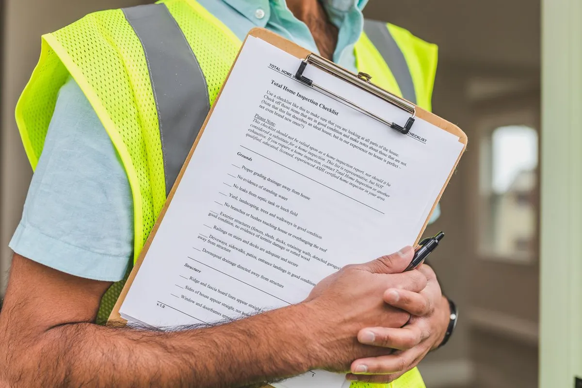 Auditor holding a checklist during a food safety certification audit