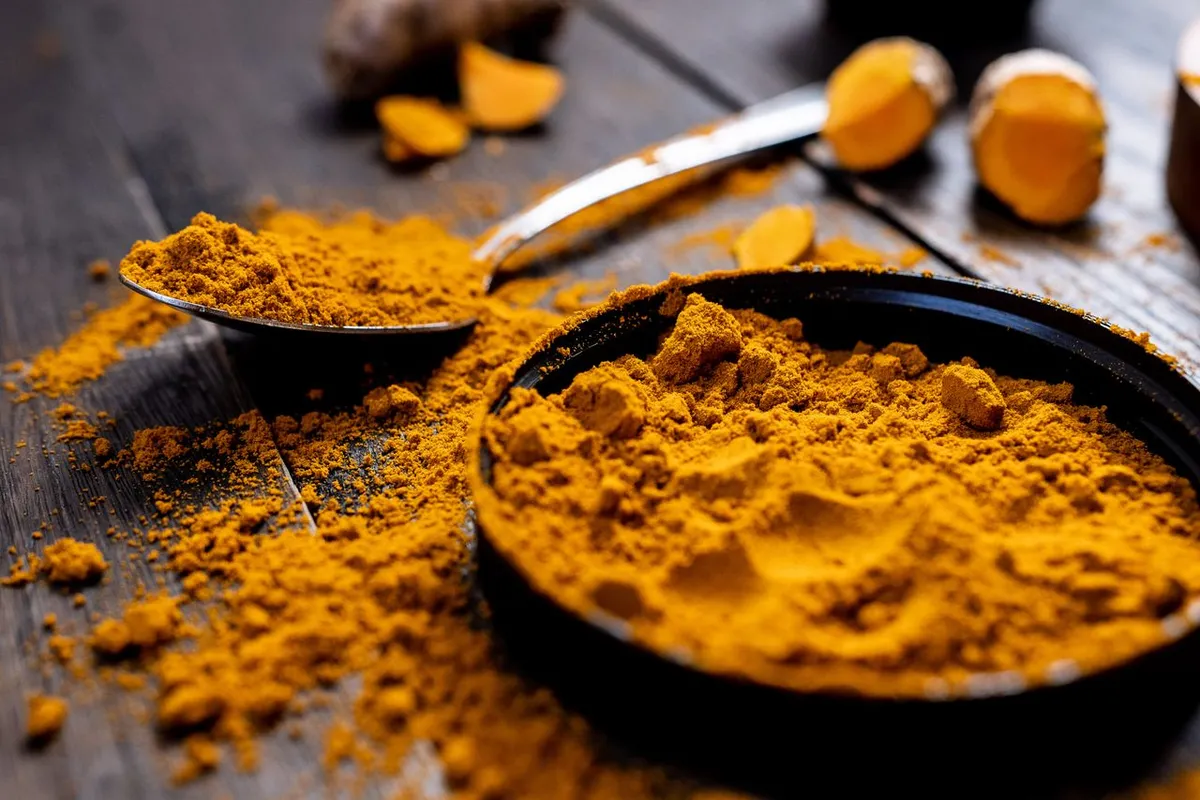 Bright turmeric powder and roots, the colour that attracts adulteration