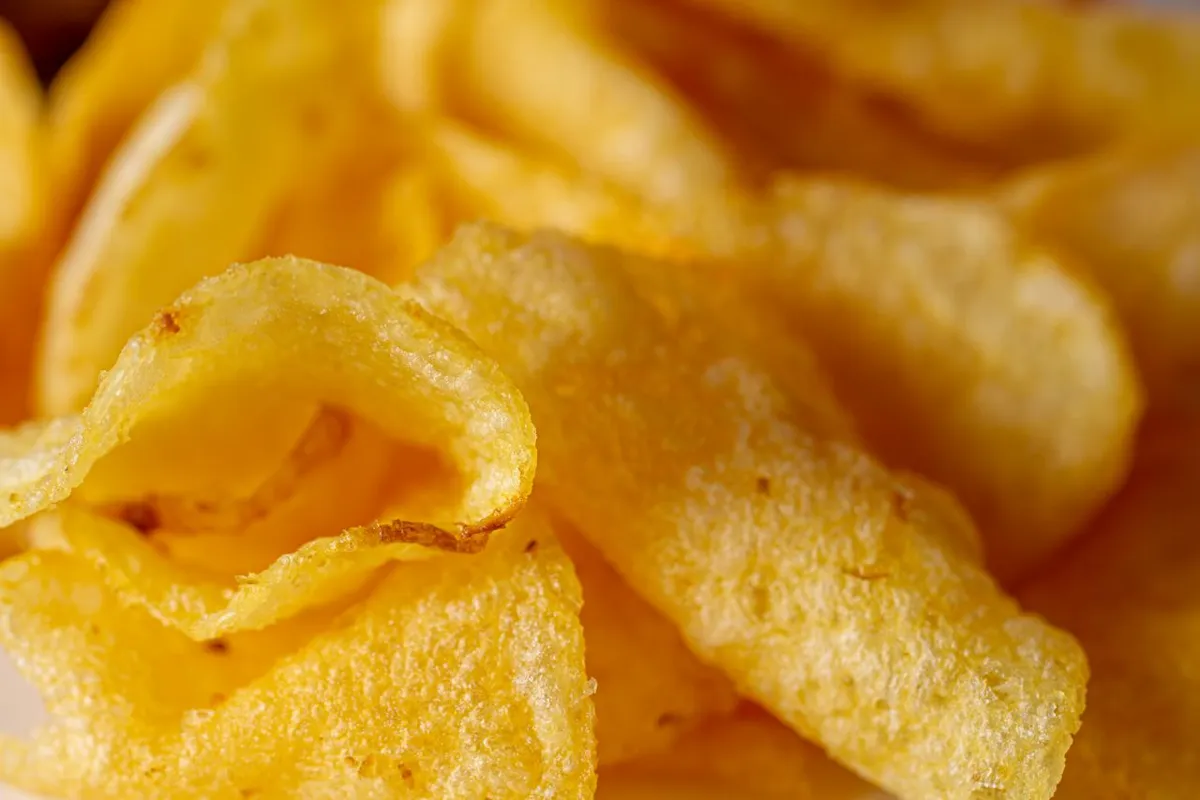Close-up of potato chips coated with onion and garlic seasoning