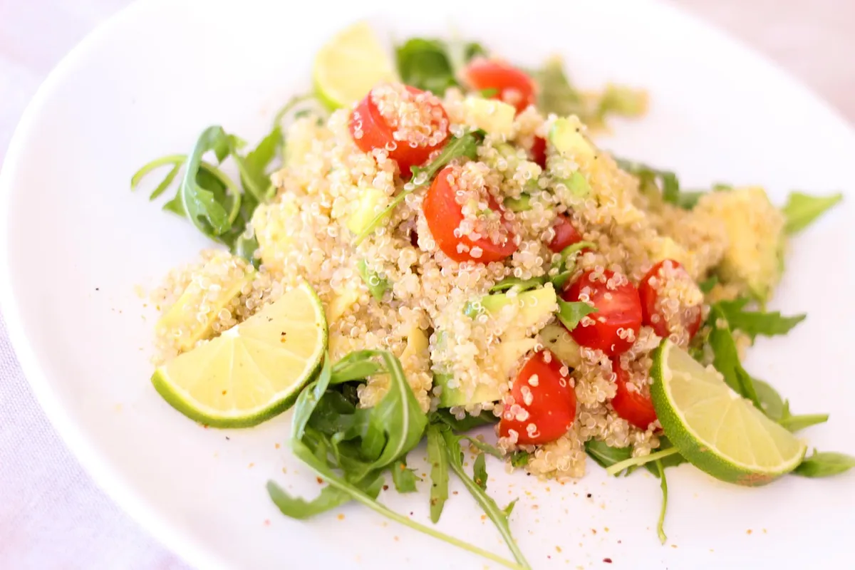 Cooked quinoa salad with tomatoes and lime showing cooked quinoa nutrition