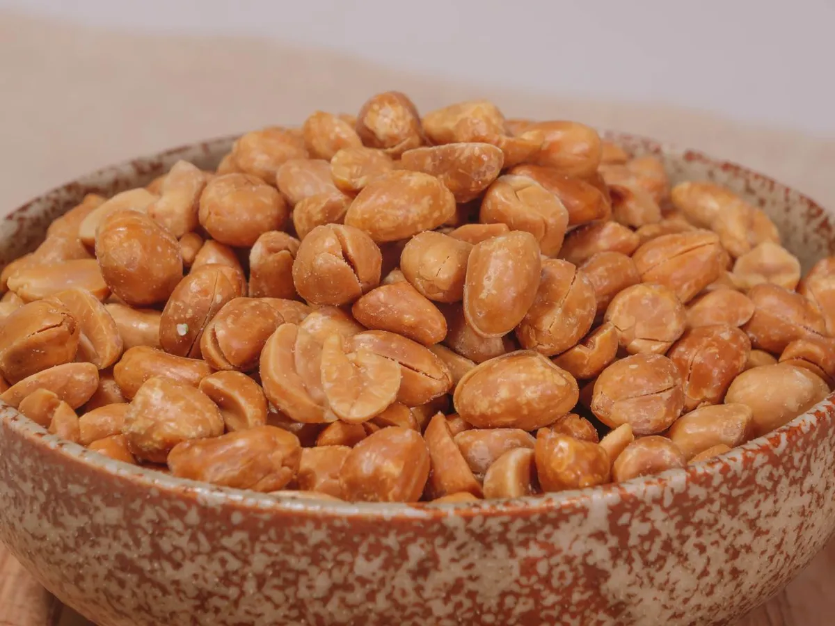 Bowl of roasted peanuts, whose nutrition differs slightly from raw