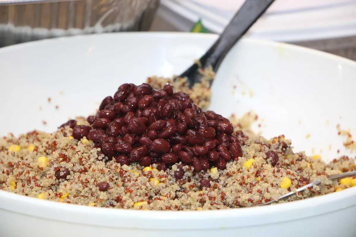 Tricolour quinoa mixed with black beans in a bowl
